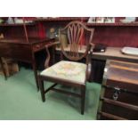 A George III mahogany shield back elbow chair with fretwork central back splat over a needlepoint