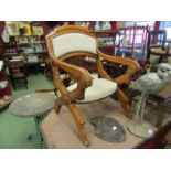 A Victorian walnut open chair with a hinged movement to arm supports,