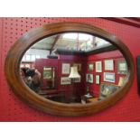 An Edwardian inliad strung mahogany oval wall hanging mirror, 69.