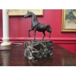 A bronze horse on marble plinth, signed L.