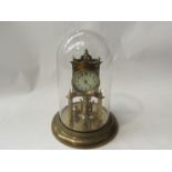A Continental brass anniversary clock stamped DRGM 403658, with glass dome,