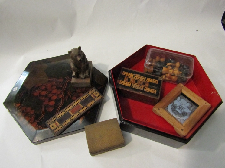 An old lacquer box with wooden chess set, cribbage board, Black Forest bear,