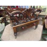 A Victorian walnut Canterbury, scroll shell motif, turned supports, single drawer, brass castors,