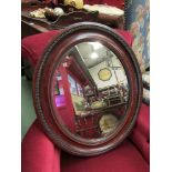 An antique oval bevelled mirror,