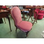 An early Victorian walnut bedroom chair the spoon backrest with carved crest over scroll front