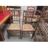 A pair of Edwardian oak chairs with see grass seats