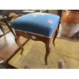 A 19th Century walnut foot stool with blue wool work top