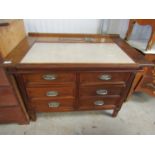 An Art Deco satinwood ships desk with sliding top over six drawers