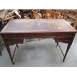 An Edwardian mahogany five drawer desk with leather top, by Howard & Sons,