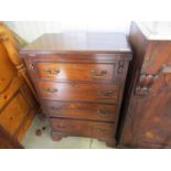 An Edwardian mahogany bachelor's chest of four slim drawers with fold over top