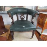 A Victorian oak desk arm chair with green leather upholstery