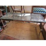 A 1920s brass and glass coffee table