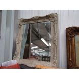 A bevelled glass mirror, painted frame.