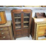 A 1940s oak and lead glazed display cabinet/ bookcase