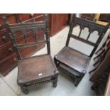 A pair of Victorian Jacobean revival oak hall chairs