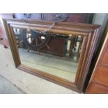 A 1930s oak framed wall mirror with bevelled glass 113 x 82cm