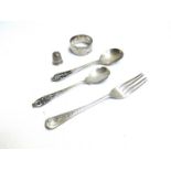 Silver including napkin ring, thimble, fork and two spoons with pierced handles,