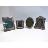 Four various silver photograph frames including wrythen form