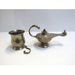 A silver oil lamp with bird form handle weighted base, marks rubbed.