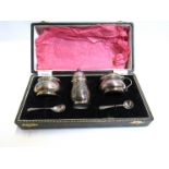 A Reid & Sons silver Lindisfarne pattern three piece cruet with Celtic design, Birmingham 1960,