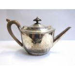 A Georgian Robert Sharp silver teapot with faint engraved crest, treen knop and handle, London 1798,