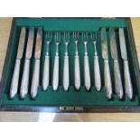 A cased set of six silver handled and bladed knives and forks,