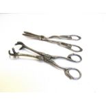 A pair of Goldsmiths & Silversmiths Co Ltd silver grape scissors and a pair of plated sugar tongs,