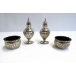 A pair of silver salts, Birmingham 1896 and a pair of pepperettes, Birmingham 1913, dents present,