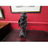 A carved Oriental ebonized gentleman lamp base,