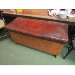 An 18th Century style embossed leather seat elm chest with arched end feet and brass stud
