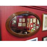 An Edwardian inlaid strung mahogany oval wall hanging mirror, 69.