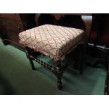 An 18th Century walnut stool on swash turned legs and stretchers,