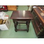 An oak joint stool on turned legs joined by stretchers,