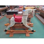 A dappled painted rocking horse on trestle rocker, approx.