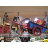 A model camel with wooden cart and three soft filled toys