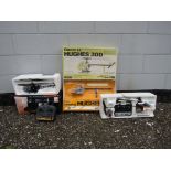 Three radio controlled helicopters including Kyosho Convert EX Hughes 300,