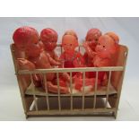 Two 1940's Japanese celluloid girl dolls and three boys in a vintage wooden dolls cot (6)