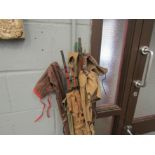 Eight vintage fishing rods in canvas bags and a fisherman rucksack with hooks and flies etc.