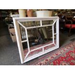 An OKA sectioned white painted mirror,