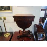 A Victorian rosewood sewing table on plateau base, bun feet to castors, two drawers and faux drawer,