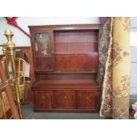 A reproduction mahogany sideboard with glazed sections and cupboard space on three door base,