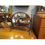 An oval swing table-top mirror