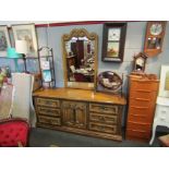 A hardwood sideboard with raised mirror-back, two rows of three drawers and central cupboard base,