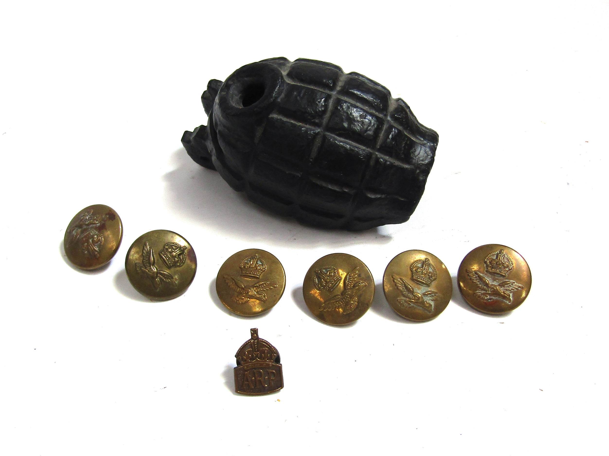 A relic Mills grenade casing blackened for display together with a set of six George VI crown RAF