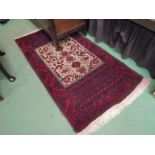 A Middle Eastern hand-knotted wool rug with central cream ground panel with birds in foliage,