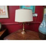 A brass effect twin bulb table lamp