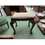 An early George III style mahogany stool with drop in seat over carved cabriole legs with carved