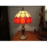 A Tiffany style table lamp base with red and cream glass