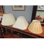 Three cream silk pleated lamp shades