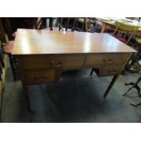 An Edwardian chequer strung inlaid mahogany desk of four drawers on square tapering legs,